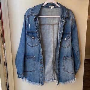 Distressed denim jacket. Size small with fringe bottom
